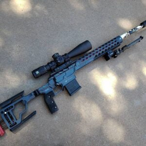 Deadline 2.0 Action precision rifle featuring a sleek black design, equipped with a scope, adjustable stock, and a barrel with custom features for enhanced performance.