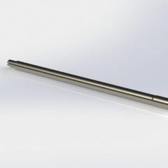 Rimfire Drop-In barrel component displayed horizontally on a reflective white surface, designed for precision firearm assembly.